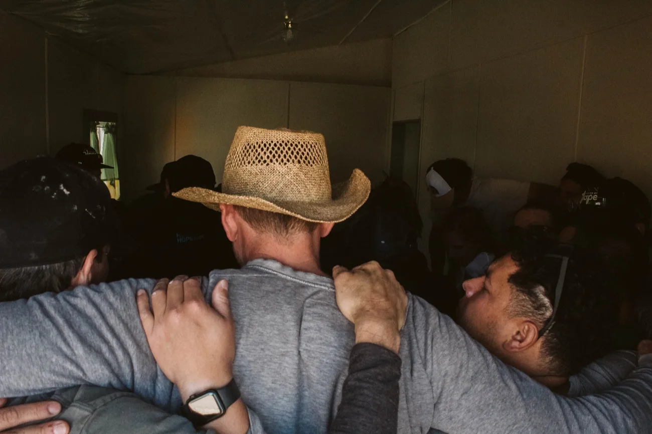 Volunteers embracing inside the finished home