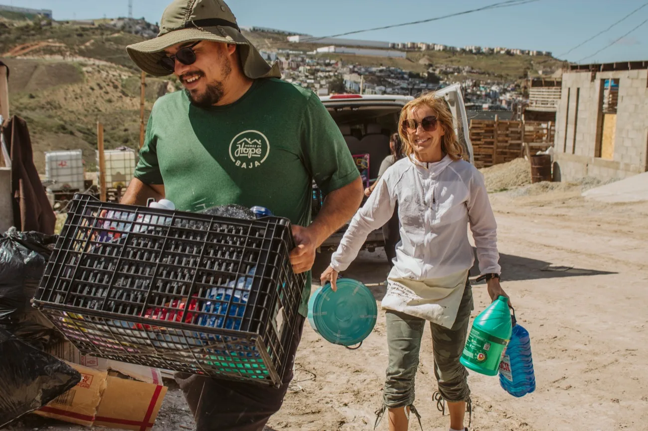 Volunteers carrying supplies to the build site